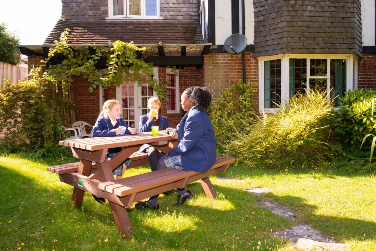 Three pupils eating lunch outside