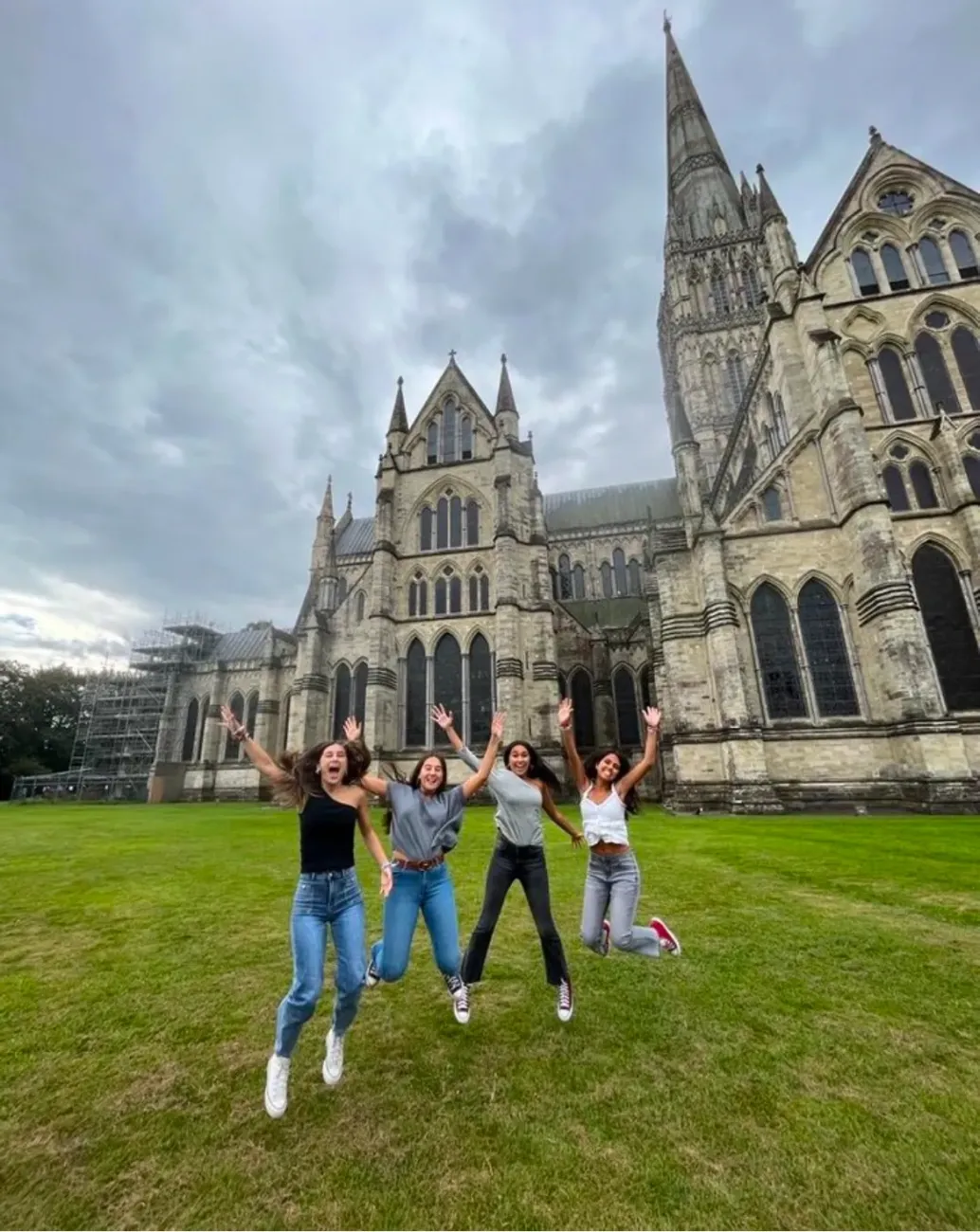 Girls jumping outside Salisbury Cathedral