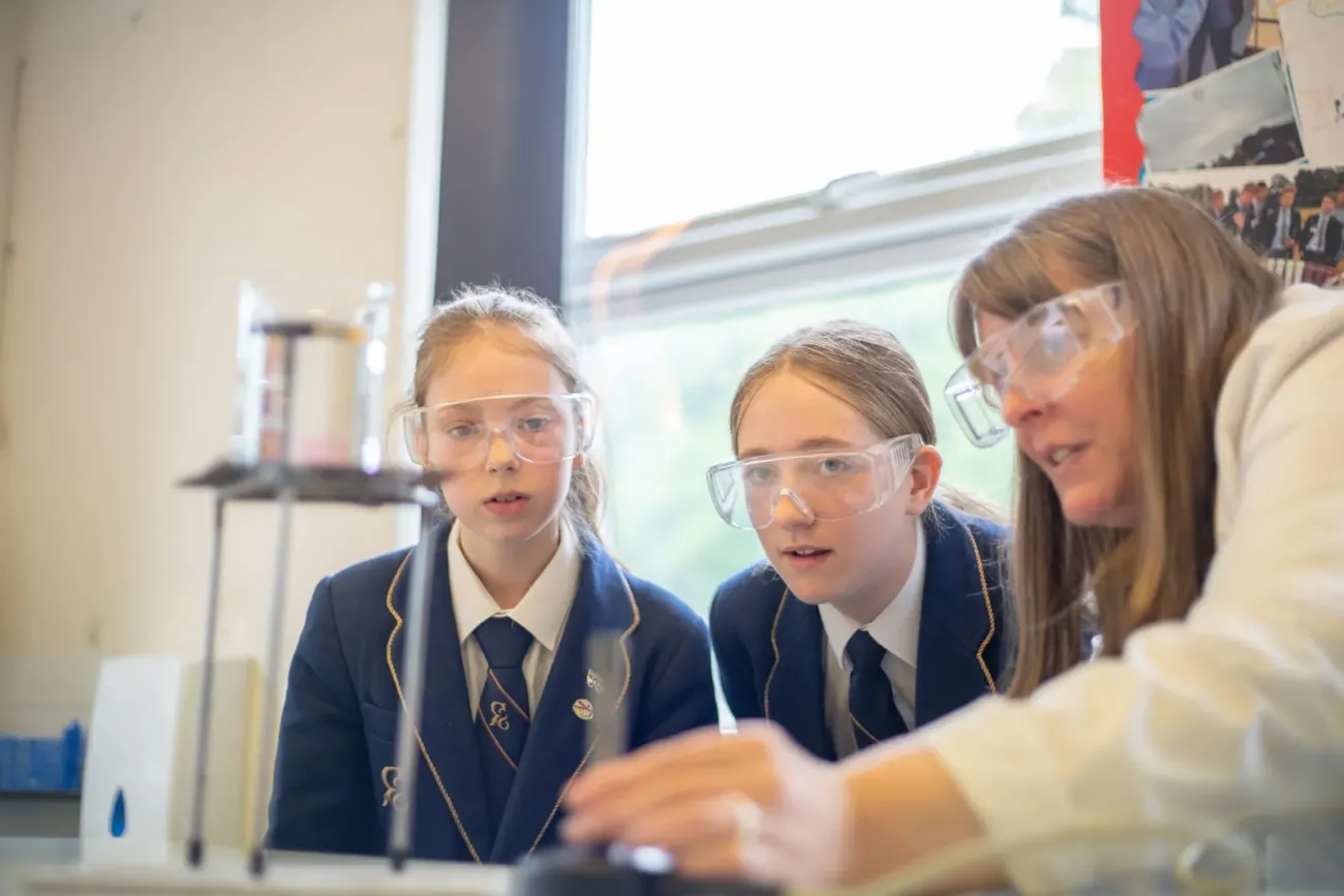 Two girls watching Rookwood School science demonstration