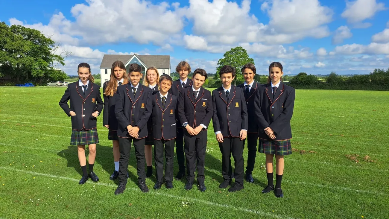 Students in school uniforms on field
