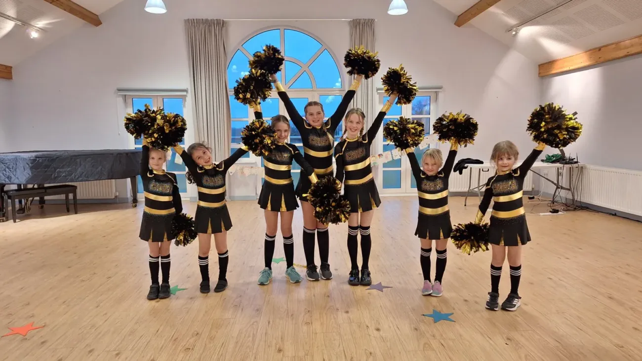 Young girls cheerleading with pompoms