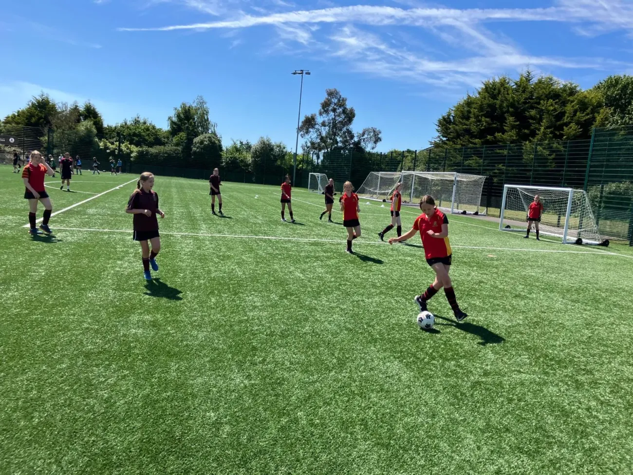Girls playing football on astroturf