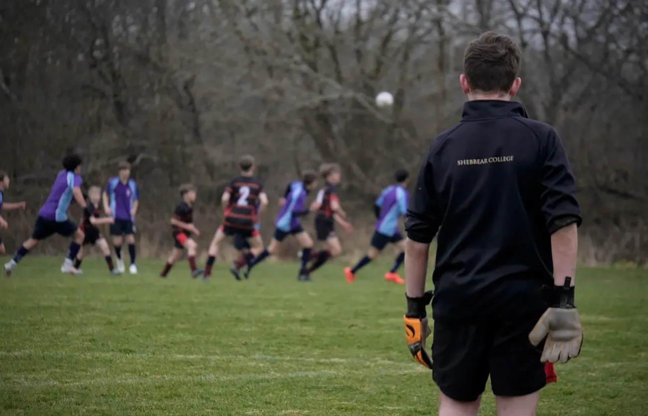 Goalkeeper watching boys football match
