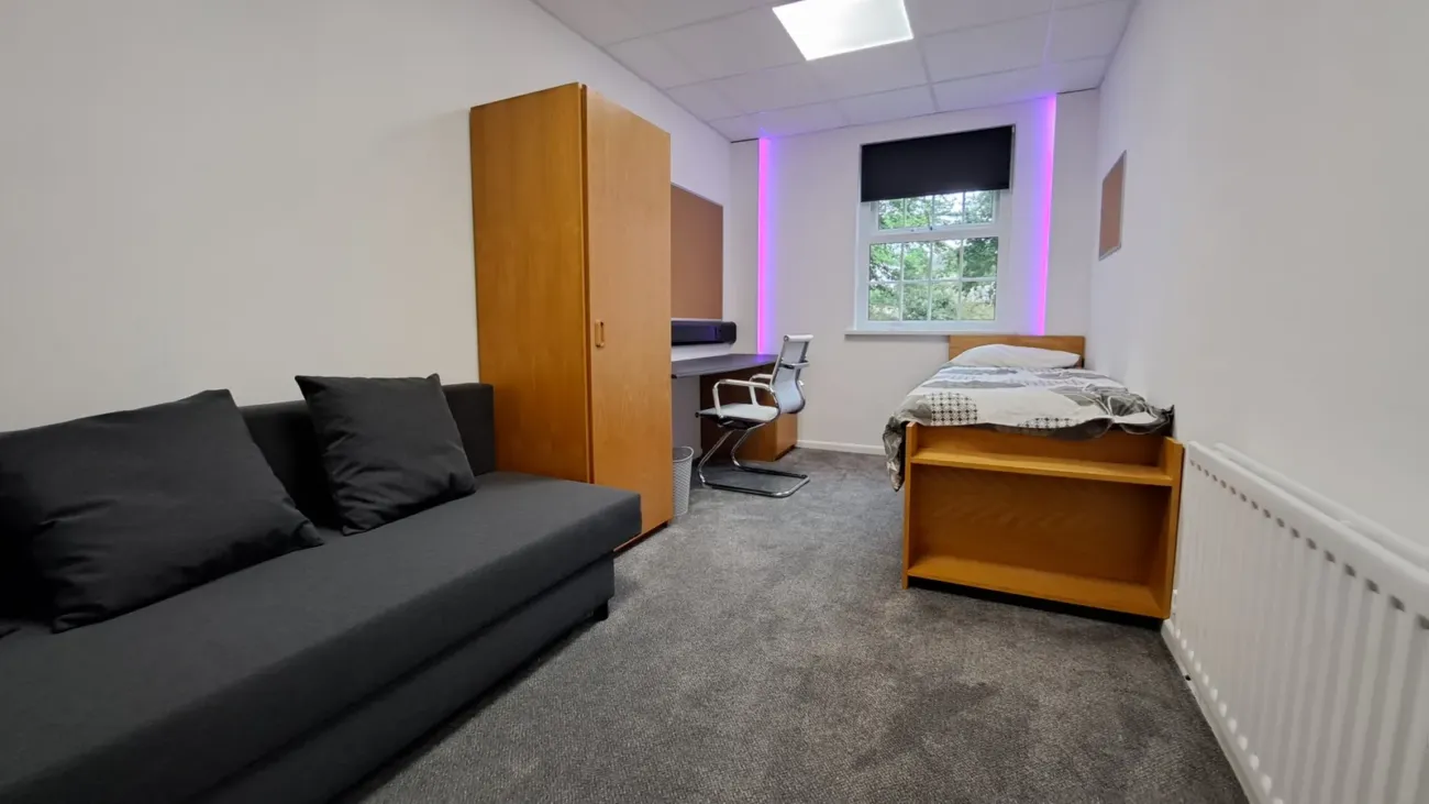 Single student bedroom with purple lighting