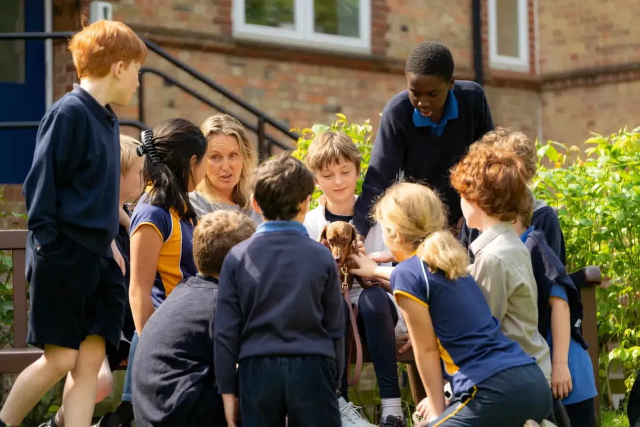 Dragon School Oxford pupils gathered outdoors with dog