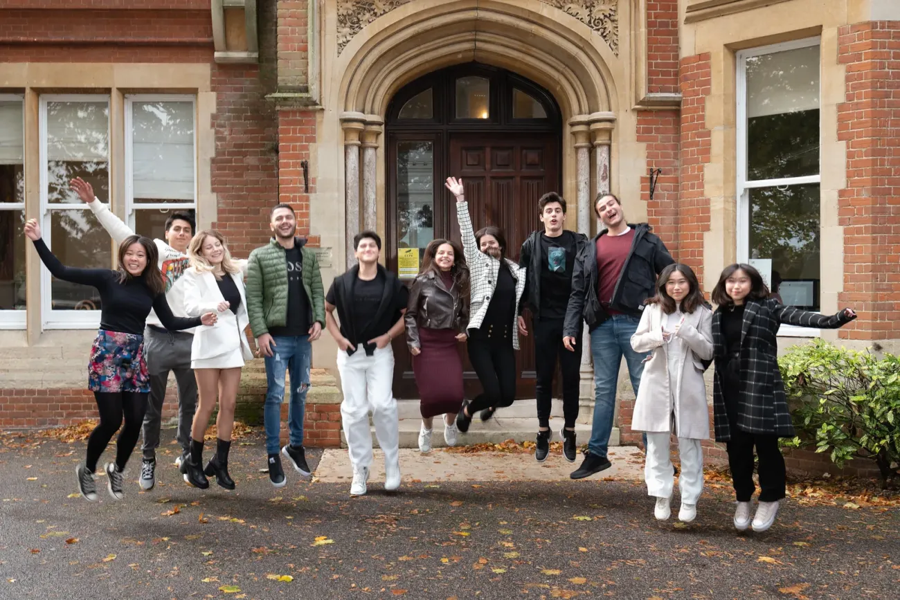 The Worthgate School students jumping outside entrance