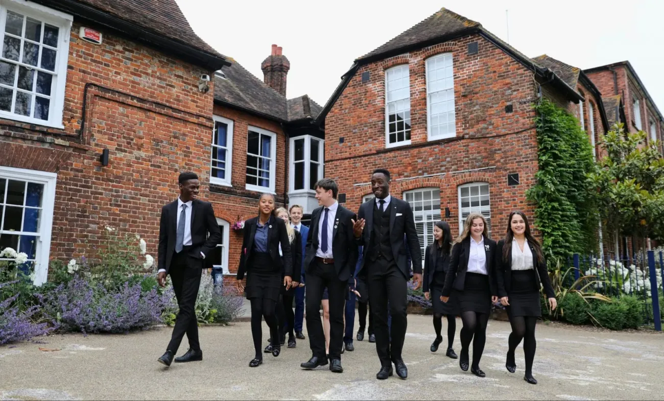 Ashford School students walking past historic buildings